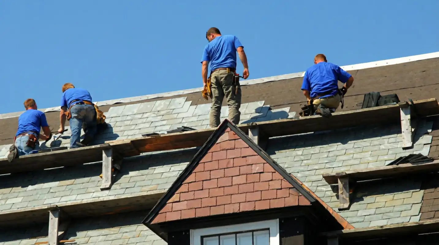 Roof replacement in progress with a team of professional contractors installing new shingles on a residential home in Toledo, OH