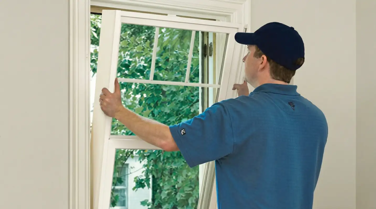 Professional contractors performing a residential window insulation and replacement service in Toledo, OH